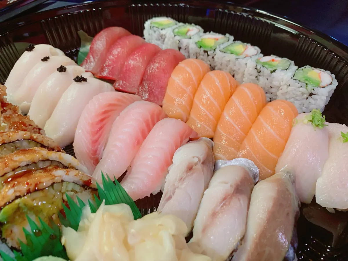 Tray of tuna, salmon and yellowtail nigiri with a California roll