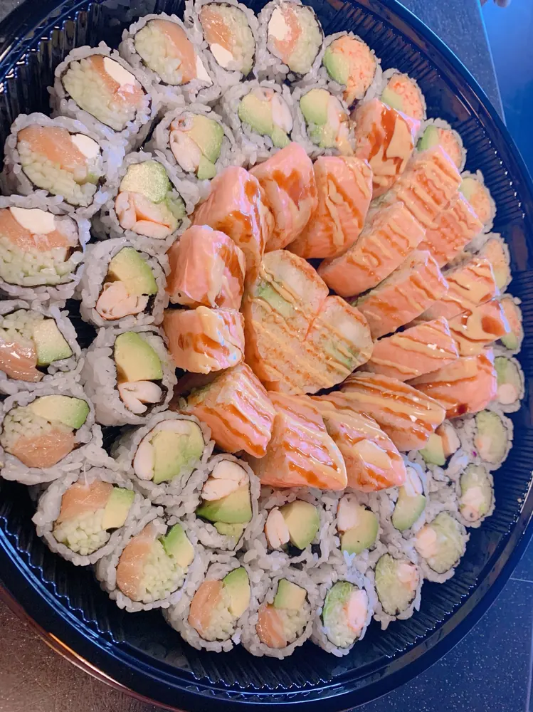 Tray of seared salmon rolls with salmon and shrimp maki